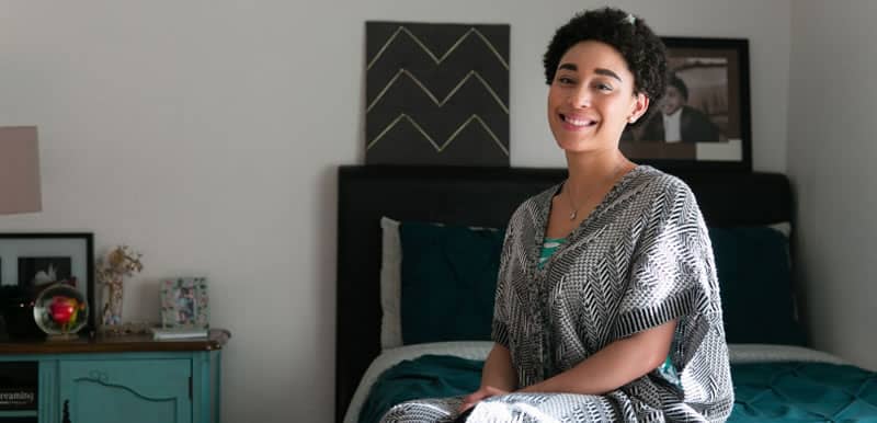 Woman sitting on a bed